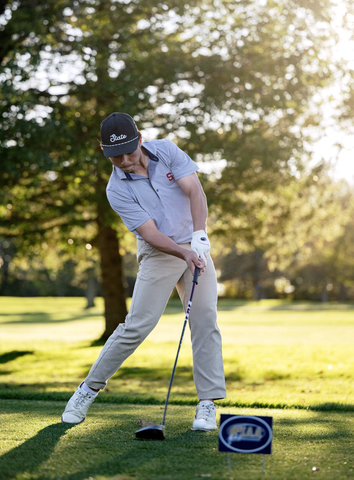 State College’s Charlie Ladrido tees off on the first hole of the playoff for the PIAA Golf Team Championships on Wednesday, Oct. 21, 2026 at the Penn State Golf Course.