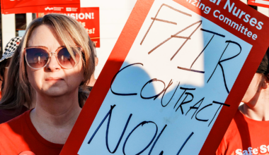 Wichita nurse holding sign "Fair contract now"