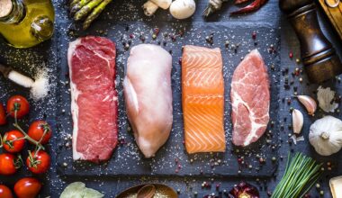 Cuts of raw meat and fish lined up on a slate serving platter.