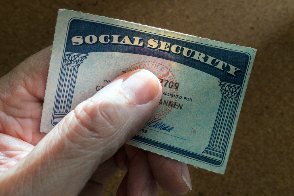 A person holding a Social Security card.