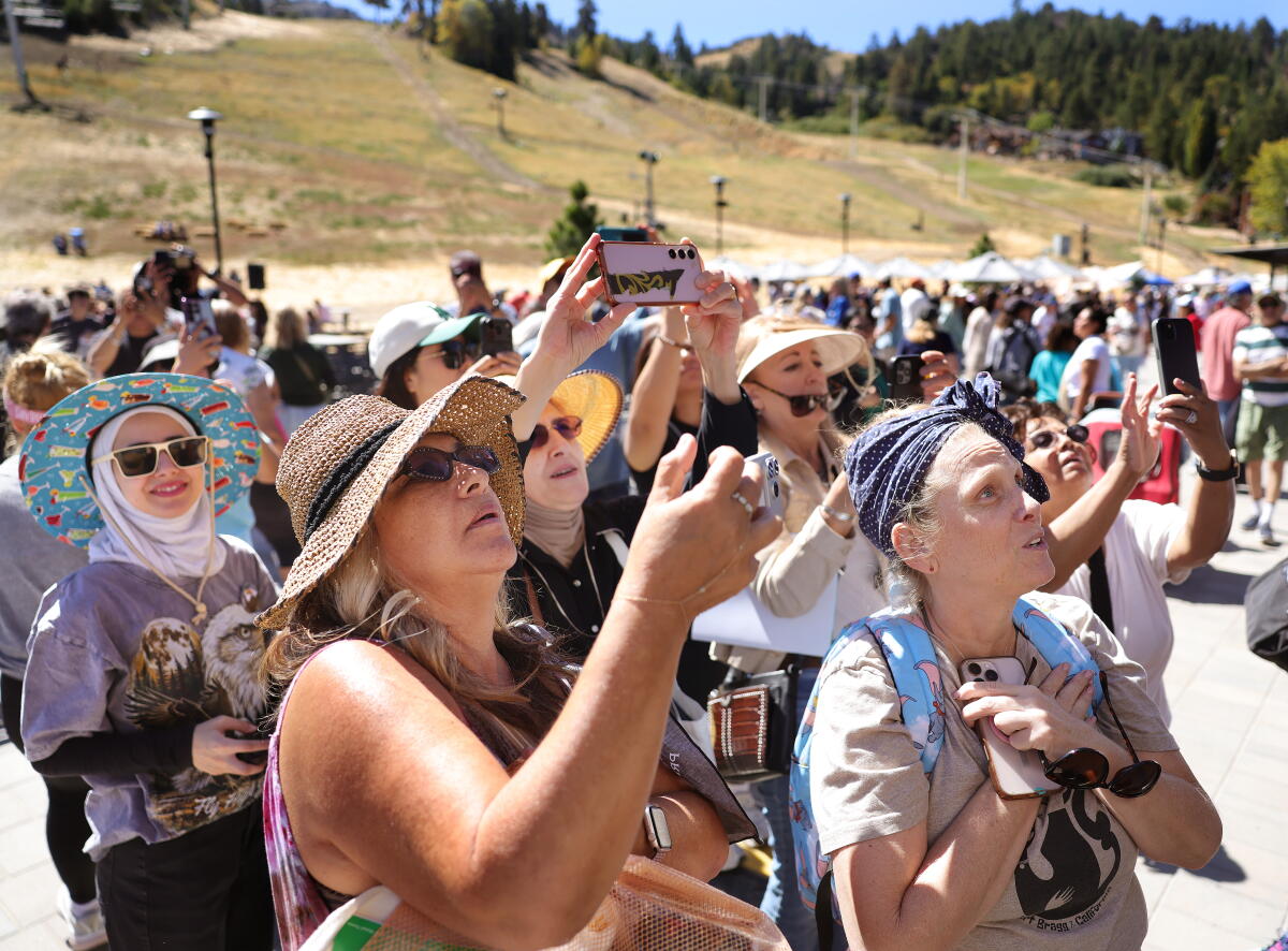 Big Bear community members and neighbors admire a painting by artist Jillana Marshall revealed during a memorial even.