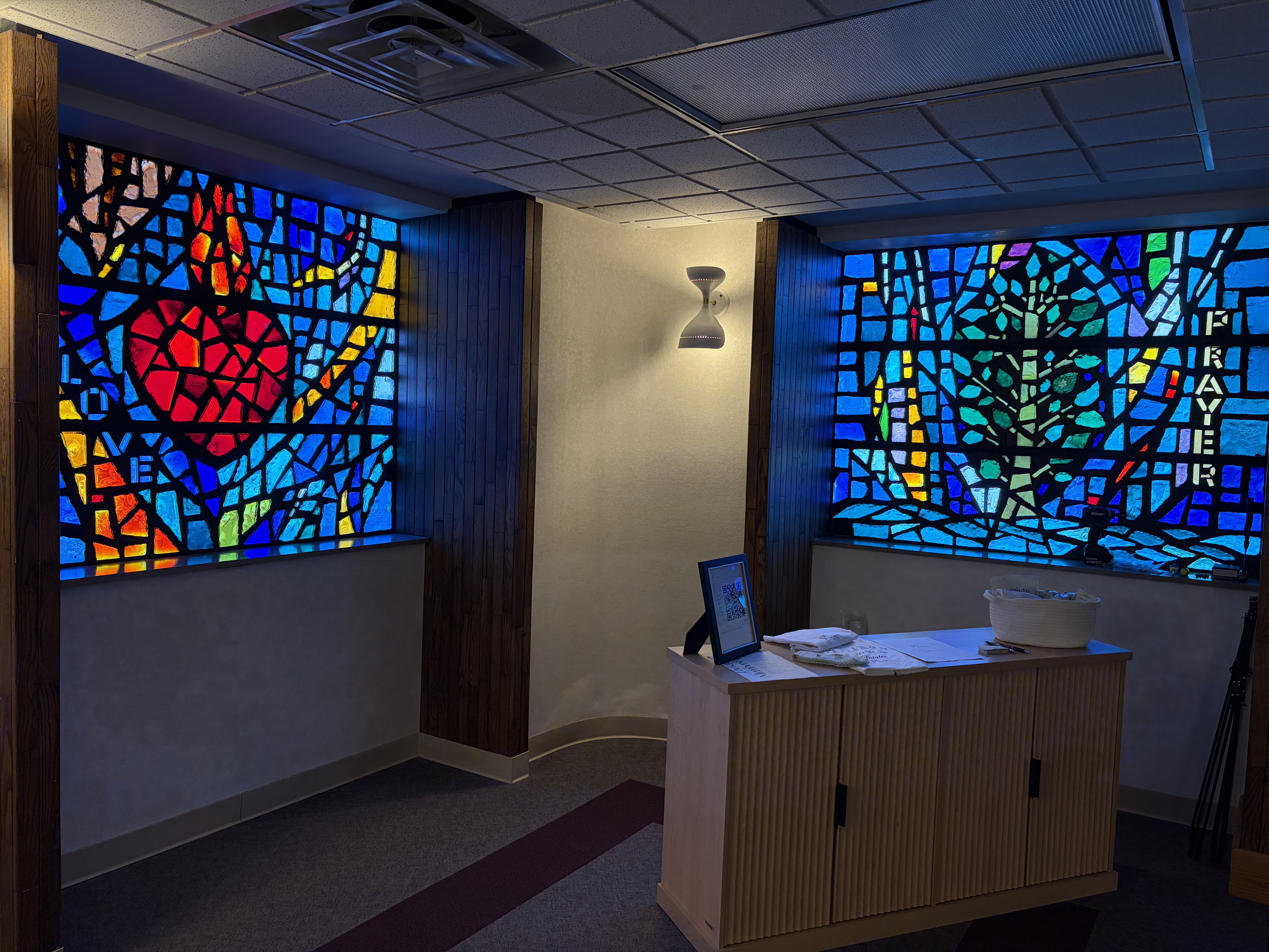 Two of the four stain-glass windows detailing the words "Love" and "Prayer" located inside Pilates & Strength Studio by Isabelle. Photo by Alin Hett/Hays Post
