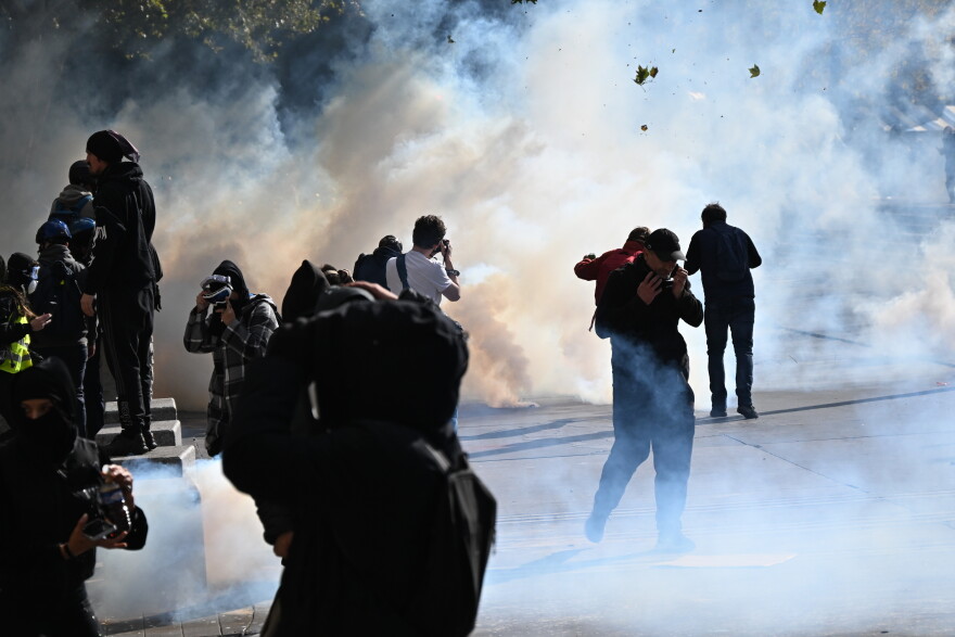 Protesters scuffle with police during a demonstration against rising living costs, joining students' grievances, in Paris on Saturday.