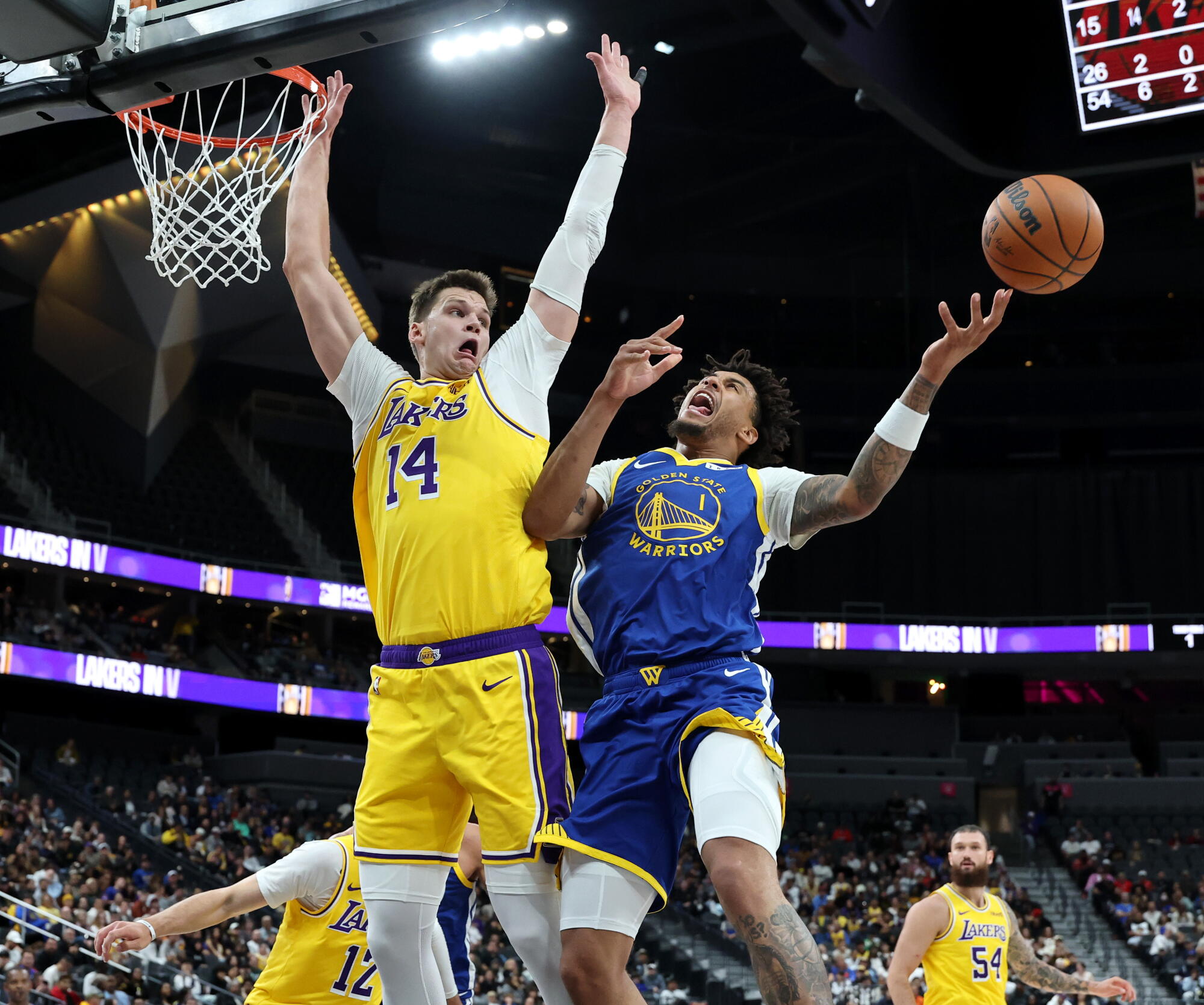 Lakers center Walker Kessler tries to block a shot by Warriors center Yaxel Lendeborg during a preseason game last week.