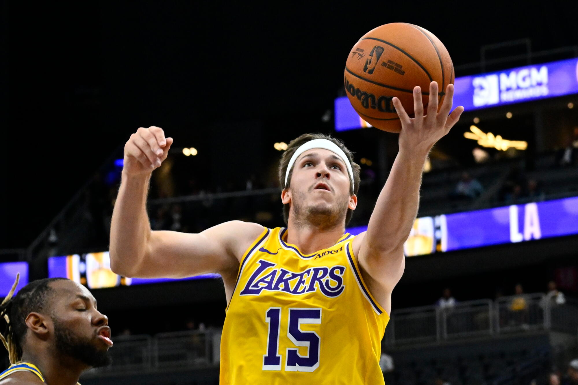 Lakers guard Austin Reaves gets past the Warriors defense for a left-handed layup.