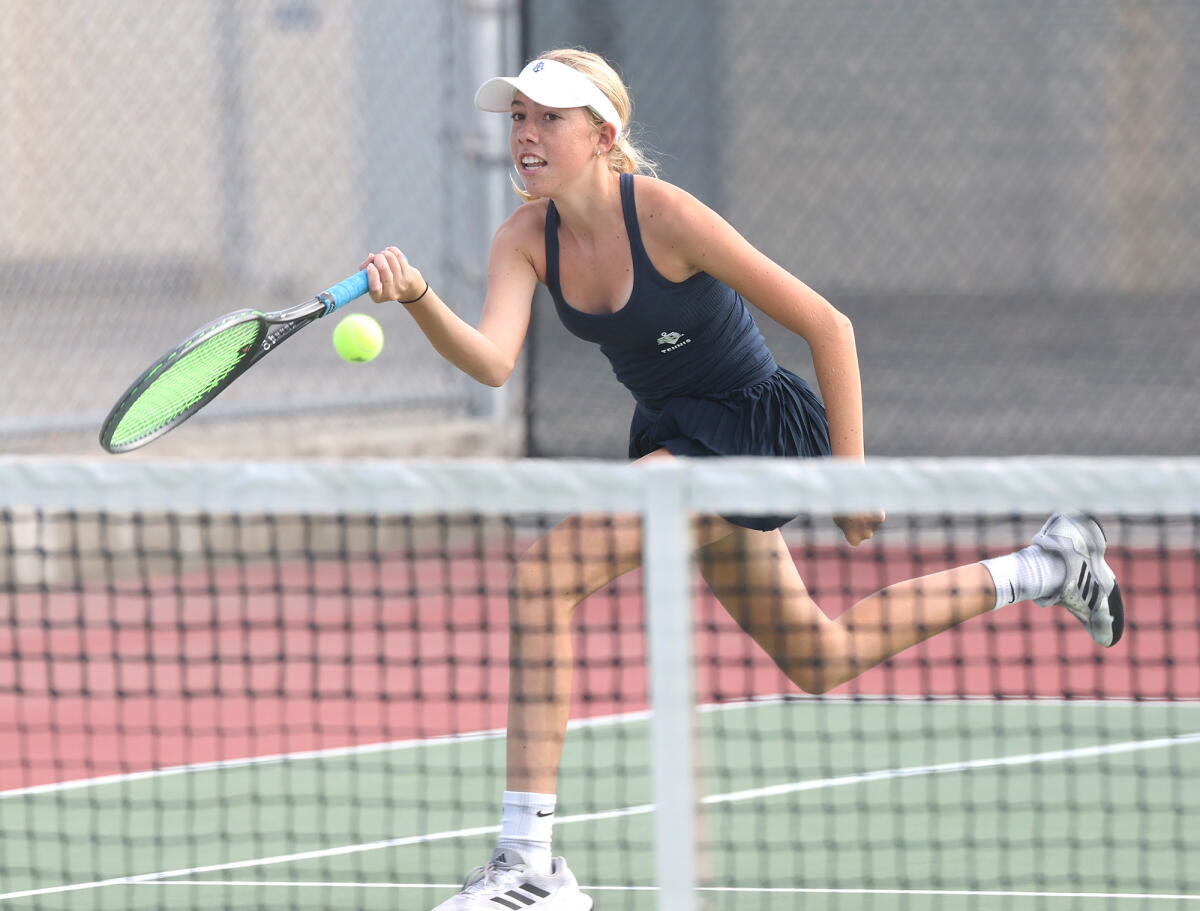 Newport Harbor singles player Coco Hine runs down a volley against Huntington Beach on Thursday.