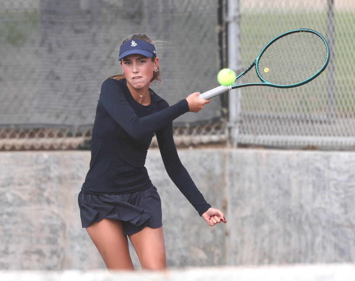 Newport Harbor doubles player Kendall McGuire hits a forehand against Huntington Beach on Thursday.