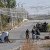 In this photo provided by Ukraine's 93rd Kholodnyi Yar Separate Mechanized Brigade press service and taken Saturday, Sept. 12, 2026, Ukrainian servicemen ride bikes under the anti-drone net in the frontline town of Druzhkivka, Donetsk region, Ukraine.