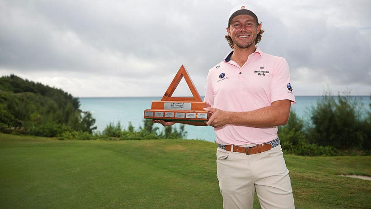 Austin Smotherman of the United States celebrates with the trophy after a sudden death playoff following the weather cancelled final round of the Butterfield Bermuda Championship 2026 at Port Royal Golf Course on October 26, 2026 in Southampton, Bermuda.