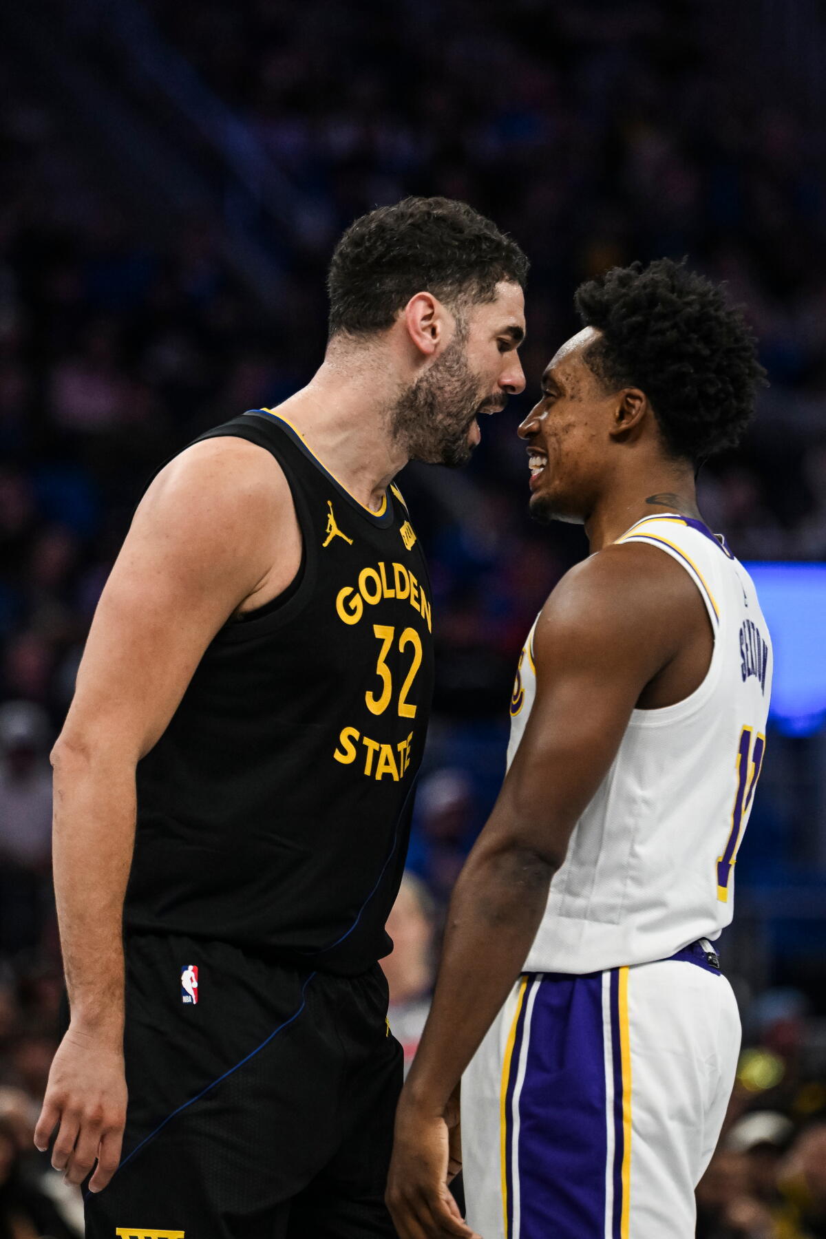 Warriors forward Georges Niang, left, and Lakers guard Collin Sexton go nose to nose as they exhange words on Friday.