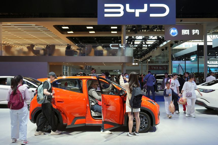 Visitors check a BYD Seagull electric vehicle (EV) displayed at the Beijing International Automotive Exhibition, or Auto China, in Beijing, China April 26, 2026.