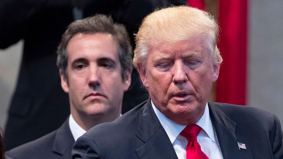 Michael Cohen stands behind Donald Trump
