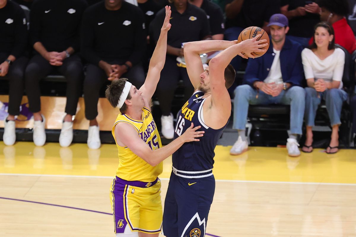 Los Angeles Lakers G Austin Reaves (15) defends against Denver Nuggets C Nikola Jokic (15) during an NBA basketball game, Friday October 16, 2026 in Los Angeles, Calif. Los Angeles Lakers G Austin Reaves (15) defends against Denver Nuggets C Nikola Jokic (15) during an NBA basketball game, Friday October 16, 2026 in Los Angeles, Calif.