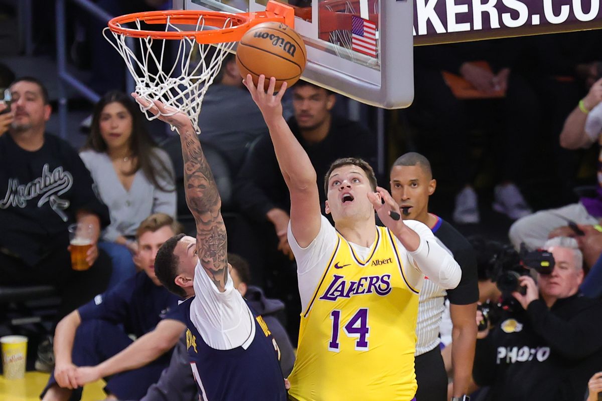 Los Angeles Lakers C Walker Kessler (14) shoots a lay up during an NBA basketball game against the Denver Nuggets, Friday October 16, 2026 in Los Angeles, Calif. Los Angeles Lakers C Walker Kessler (14) shoots a lay up during an NBA basketball game against the Denver Nuggets, Friday October 16, 2026 in Los Angeles, Calif.