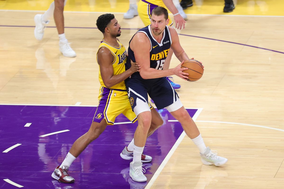 Los Angeles Lakers G Quentin Grimes (5) defends against Denver Nuggets C Nikola Jokic (15) during an NBA basketball game, Friday October 16, 2026 in Los Angeles, Calif. Los Angeles Lakers G Quentin Grimes (5) defends against Denver Nuggets C Nikola Jokic (15) during an NBA basketball game, Friday October 16, 2026 in Los Angeles, Calif.