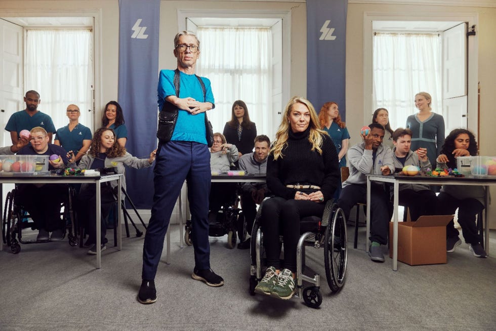 diverse group of people, some in wheelchairs, gathered in a classroom setting.
