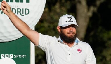Tyrrell Hatton holds his arm out on the golf course
