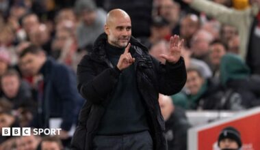 Manchester City manager Pep Guardiola holds up six fingers to indicate the six premier league titles he has won after Liverpool fans sing 'You're Getting Sacked it in Morning'