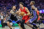 Portland Trail Blazers forward Deni Avdija, center, drives to the basket with Sacramento Kings guards Emanuel Sharp (34) and Malik Monk (0) defending during the first half of an NBA basketball game Friday, Oct. 23, 2026, in Sacramento, Calif.