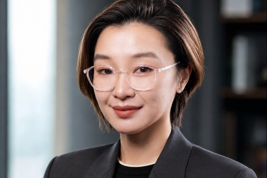 Lady with dark hair wearing glasses