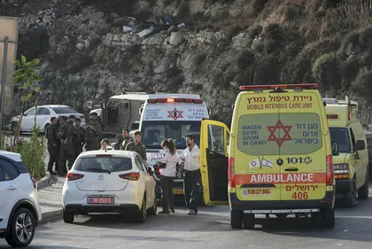 Israeli soldiers and emergency personnel gather near ambulances following a shooting attack near Hebron, in the West Bank, Friday.