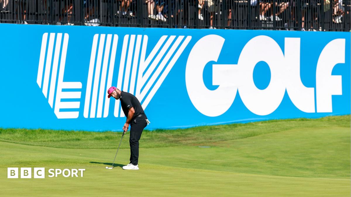 Jon Rahm playing a shot in front of a large banner saying LIV Golf