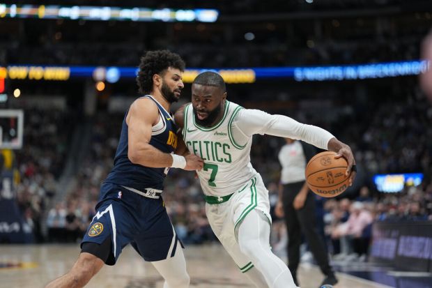 Boston Celtics guard Jaylen Brown (7) drives past Denver Nuggets guard Jamal Murray (27) in the first half of an NBA basketball game Wednesday, Feb. 25, 2026, in Denver. (AP Photo/David Zalubowski)
