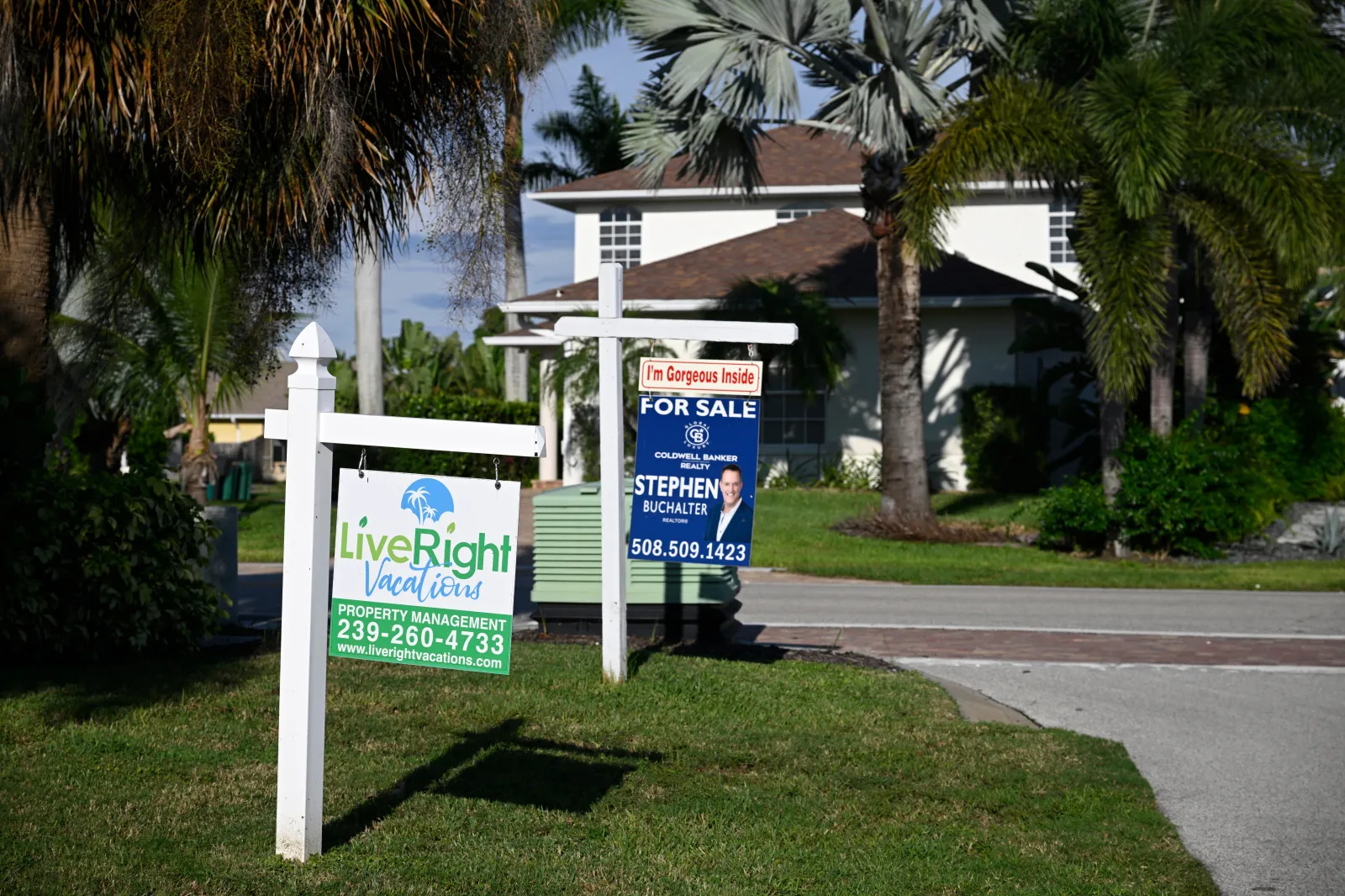 Real estate signs in front of a home for sale, Monday, September 21, 2026, in Naples, Florida.