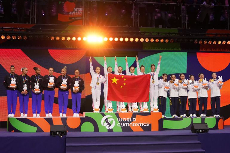 Silver medalists United States, from left, gold medalists China and bronze medalists Japan stand on the podium of the women's team final at the Artistic Gymnastics World Championships in Rotterdam, the Netherlands, Wednesday, Oct. 21, 2026. (AP Photo/Francisco Seco)