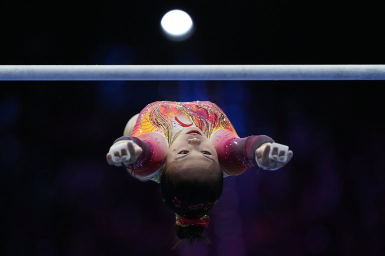 Zhang Qingying, of China, competes in the uneven bars during the women's team final at the Artistic Gymnastics World Championships in Rotterdam, the Netherlands, Wednesday, Oct. 21, 2026. (AP Photo/Francisco Seco)
