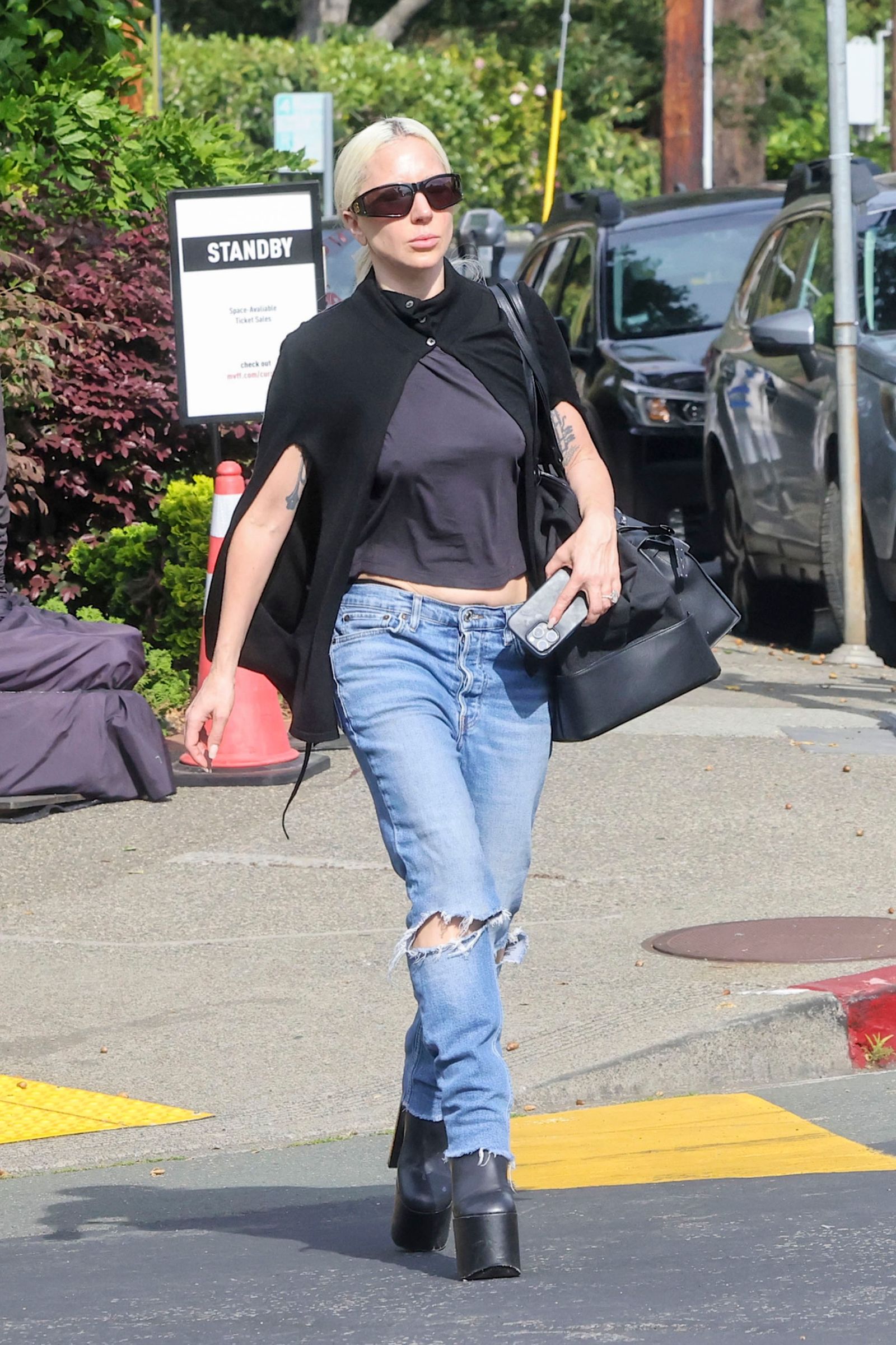 Image may contain Lady Gaga Clothing Pants Jeans Pedestrian Person Adult Car Transportation and Vehicle