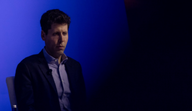 Sam Altman, CEO of OpenAI, looks offscreen with a blue background.