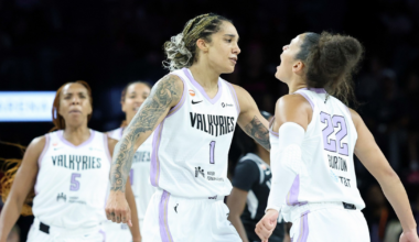 Two female basketball players in white Valkyries uniforms, numbered 1 and 22, appear to be celebrating or encouraging each other on the court.