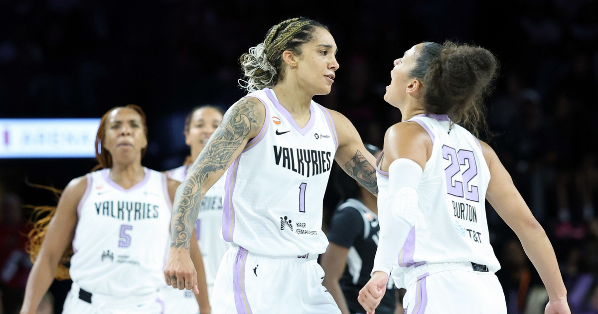 Two female basketball players in white Valkyries uniforms, numbered 1 and 22, appear to be celebrating or encouraging each other on the court.