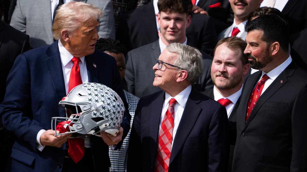 President Donald Trump, Ohio Gov. Mike DeWine and coach Ryan Day standing on the White House South Lawn