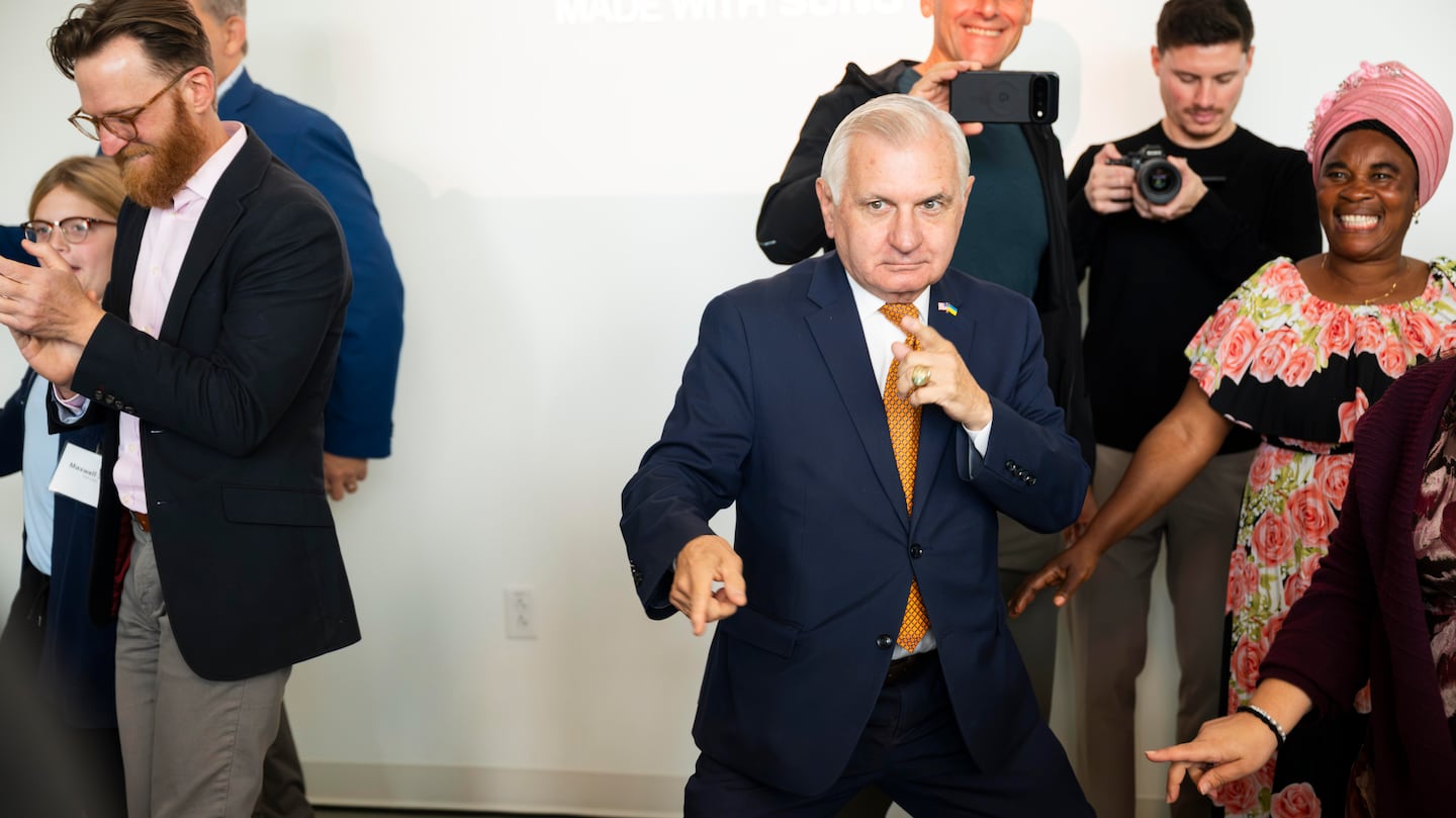 US Senator Jack Reed, center, takes part in a dance celebration during a ceremony marking the expansion of the Edesia Nutrition factory in North Kingstown, R.I.
