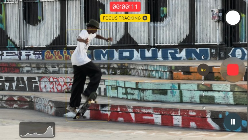 screenshot of the camera app showing focus tracking on a photo of a young man skateboarding