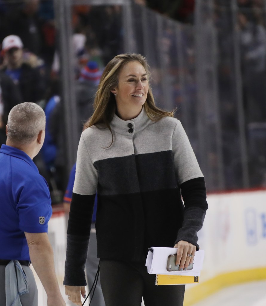 New York Rangers assistant coach Kelly Pannek smiles as she walks on the ice during a game against the New York Islanders.