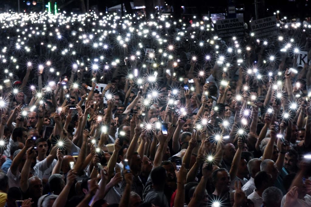 Supporters of Albania's opposition Democratic Party leader Lulzim Basha hold up their smartphones during a protest in Turana on 21 June, 2019