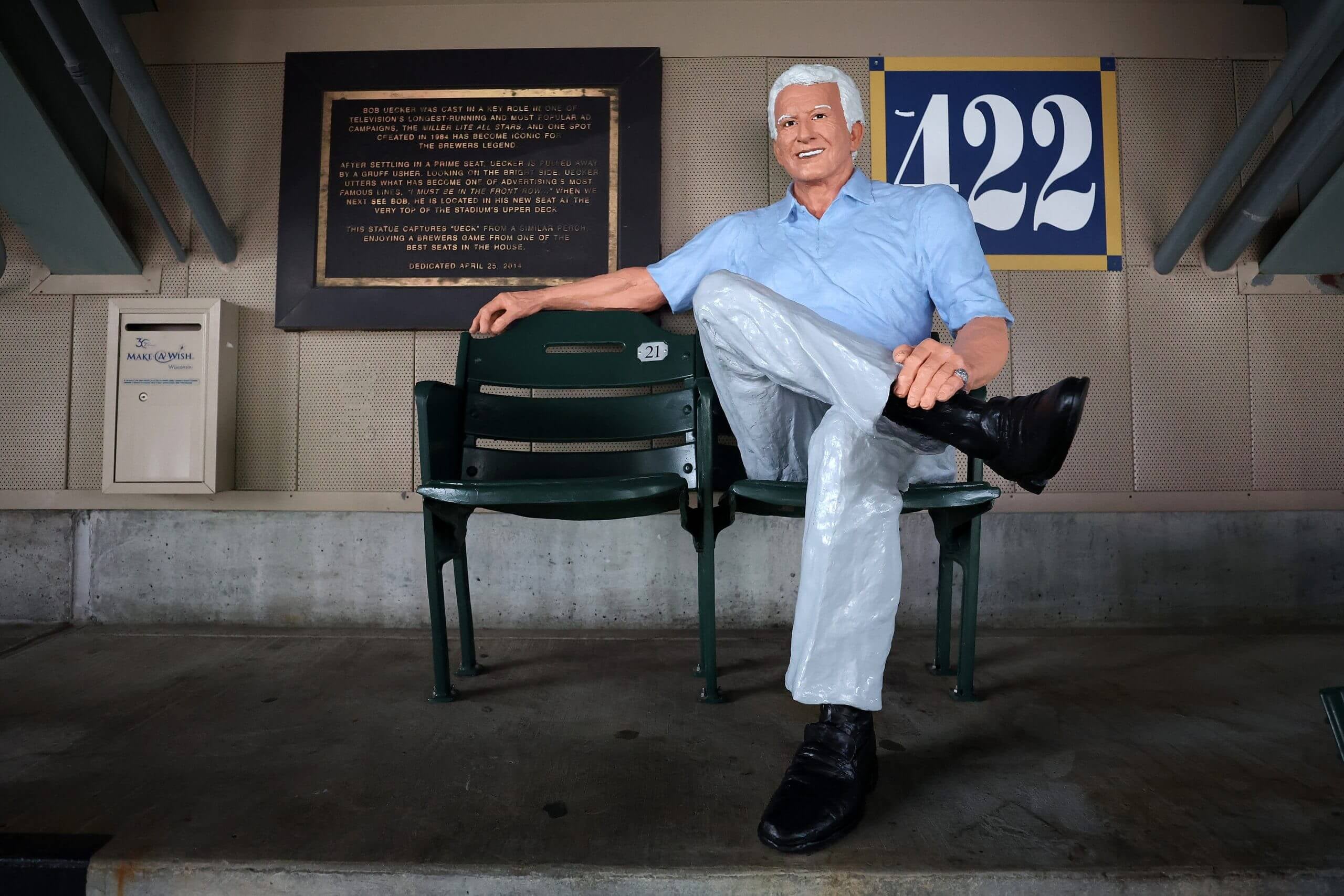 This detailed view of the famed Bob Uecker seat features an empty chair next to a likeness of the man himself.