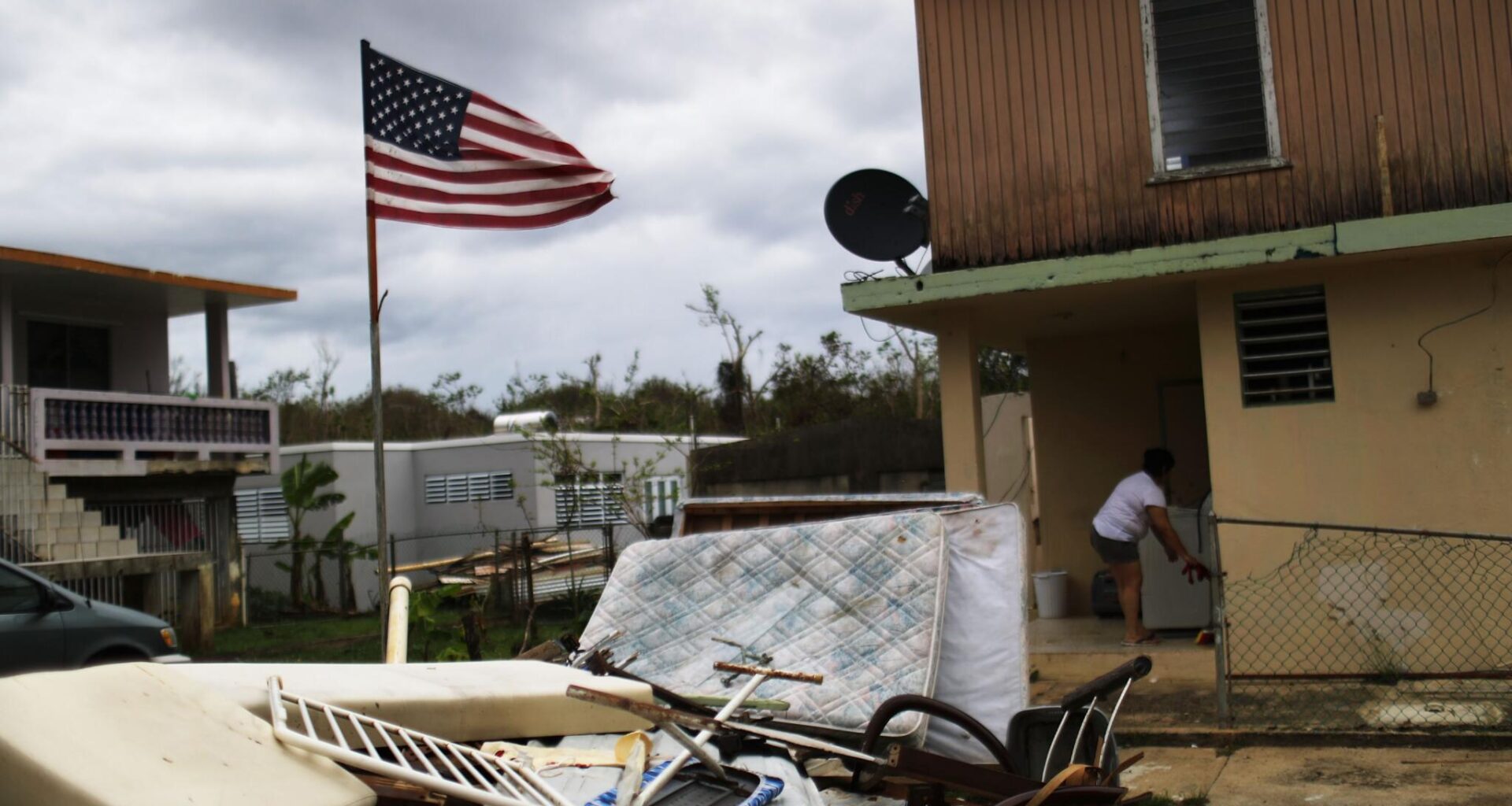 A woman stands outside of her damaged home on October 15, 2017, in Dorado, Puerto Rico, after Hurricane Maria, a Category 4 storm, hit the island. (Mario Tama/Getty Images)