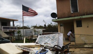 A woman stands outside of her damaged home on October 15, 2017, in Dorado, Puerto Rico, after Hurricane Maria, a Category 4 storm, hit the island. (Mario Tama/Getty Images)