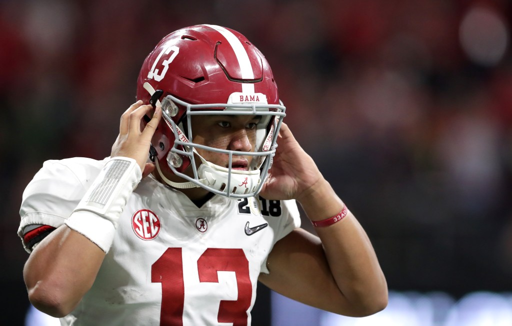 Alabama Crimson Tide quarterback Tua Tagovailoa puts on his helmet during the CFP National Championship game against Georgia.