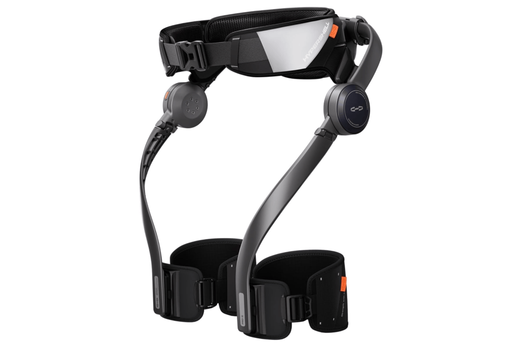 The Hypershell exoskeleton device features a black and silver waist belt and mechanical leg supports with motorized joints.