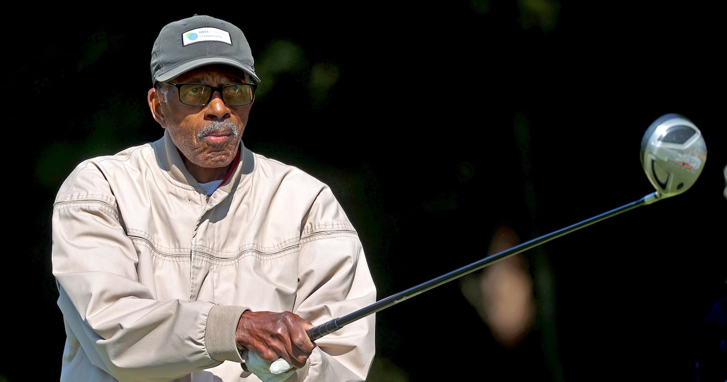 George O. Jones, 94, finishes his swing during a drive at the William J. Devine Golf Course at Franklin Park.