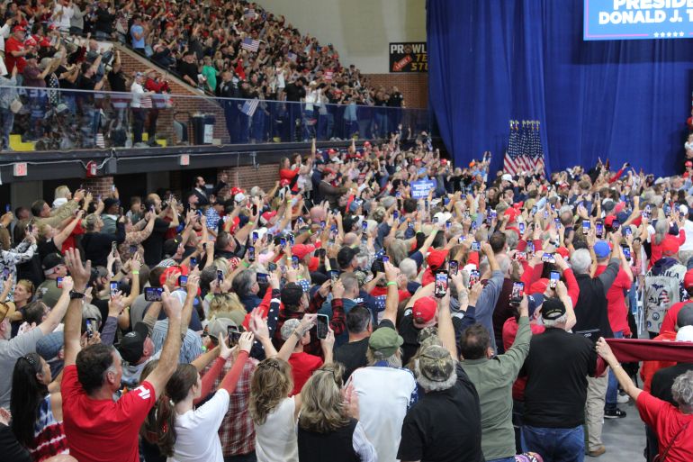 A crowd of supporters in the McMorran Place hockey arena cheers for Trump on October 25