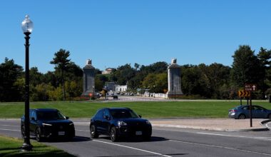 Cars drive past Memorial Circle near Arlington National Cemetery
