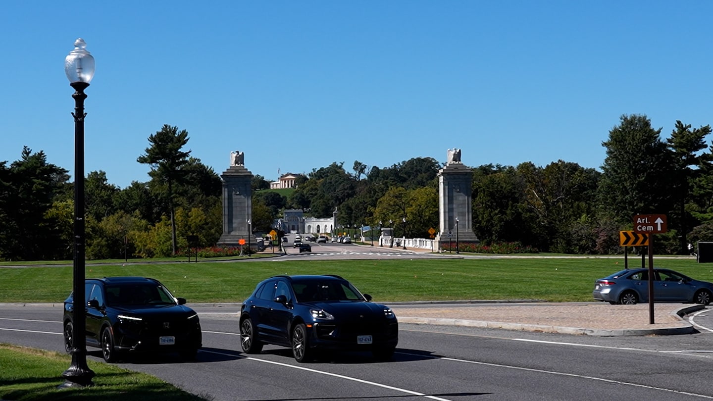 Cars drive past Memorial Circle near Arlington National Cemetery