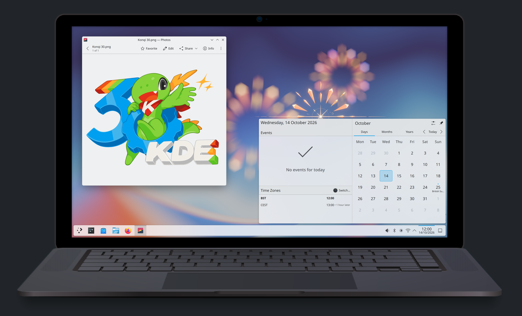 A laptop sits with an open window showing the date is Oct 14, 2026, and another with a logo celebrating KDE's 30th birthday.
