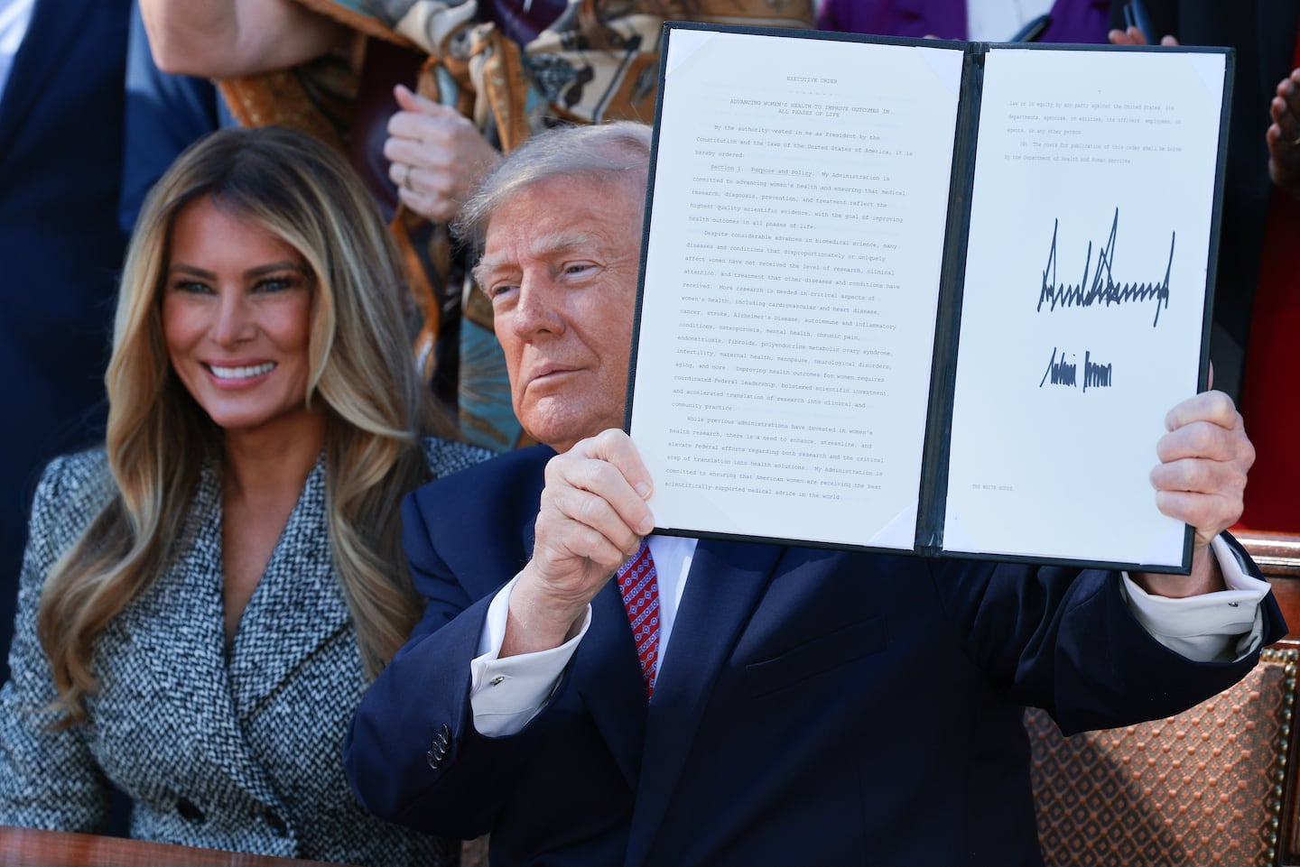 President Trump holds the executive order he and first lady Melania Trump signed in the Rose Garden of the White House on October 19, 2026 in Washington, D.C.